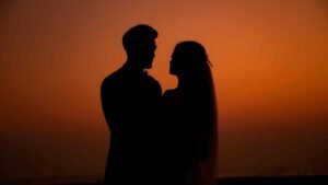 goa wedding photographer: couple lovingly gaze at each other as the photographer captures a stunning interplay of light and shadows