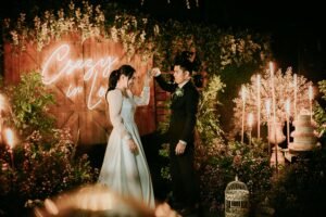 Vietnam wedding photographer captures couple dancing in a glowing background lit with candles and LEDs
