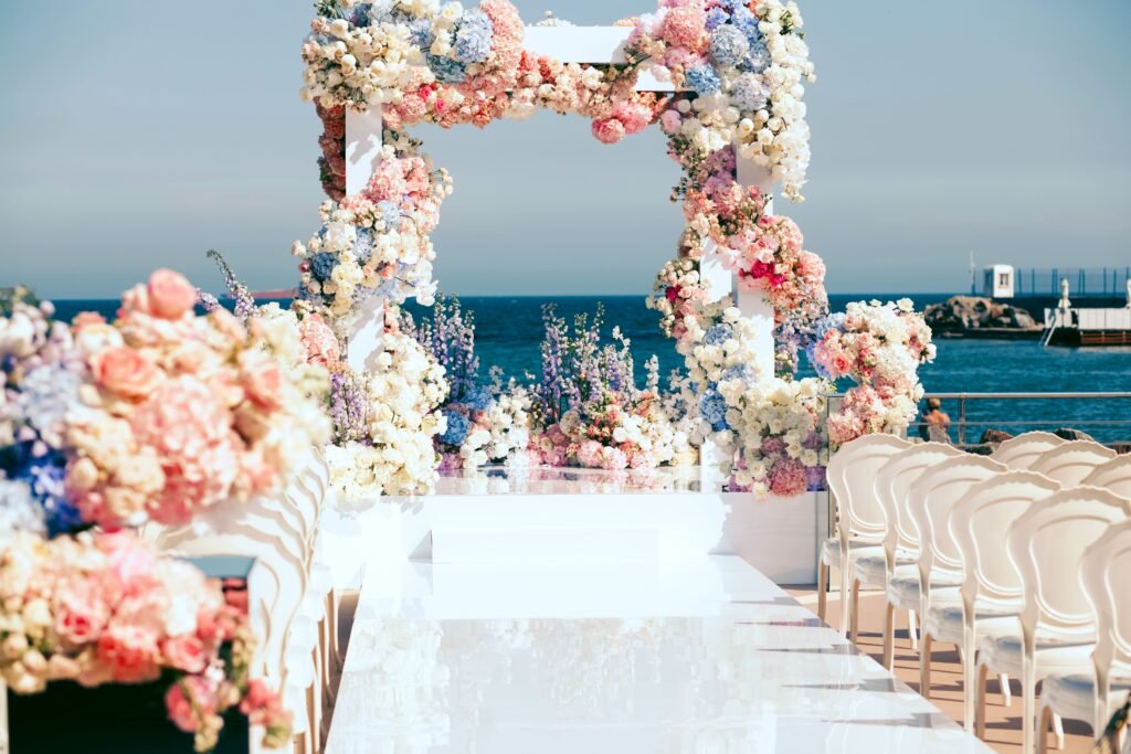 destination wedding in India: Wedding mandap by the sea adorned with pastel florals