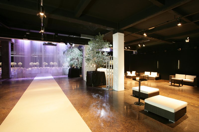 Modern indoor wedding venue setup with aisle and lounge seating; another one of the wedding venues in Milan, Italy.
