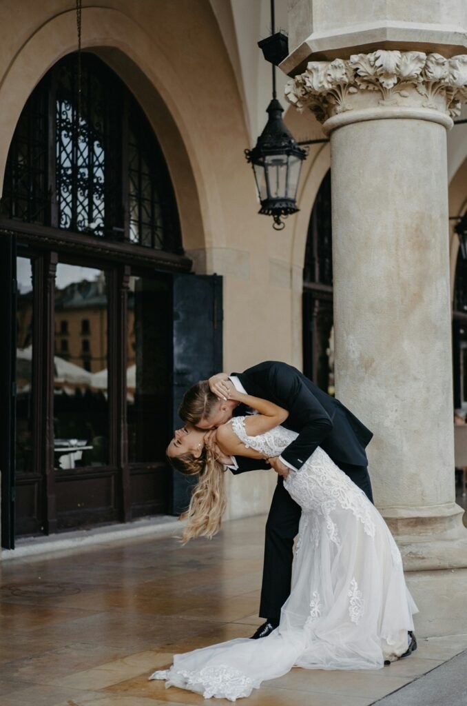 Bride and groom in historic arcade showcasing the beauty of wedding venues in Milan, Italy.