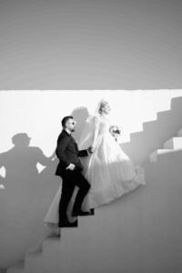 wedding photographer in Sorrento Italy: bride and groom posing for an editorial style shoot by the staircase